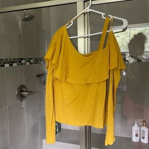 One shoulder mustard Anthropologie shirt.